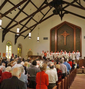 Church service with choir and people in pews.